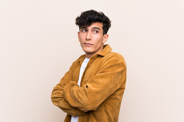 Fototapeta premium Young Argentinian man over isolated background making doubts gesture while lifting the shoulders