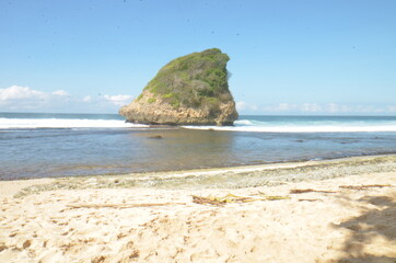 Long Exsposure at Sunrise at South Java Beach with Rock Cliff in the middle