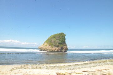 Long Exsposure at Sunrise at South Java Beach with Rock Cliff in the middle