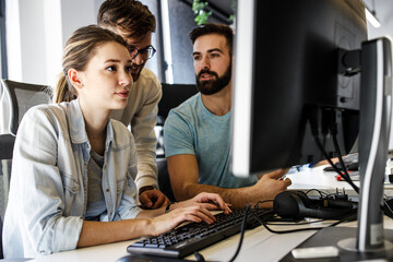 	
Group of designers  programmers working on a new project at the office.
