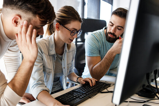 	
Group of designers  programmers working on a new project at the office.