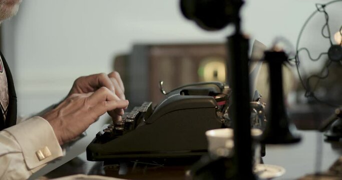 Scene Pushes Into A 1940s Era Of A Reporter Or Writer In His Office Typing On Vintage Manual Typewriter.