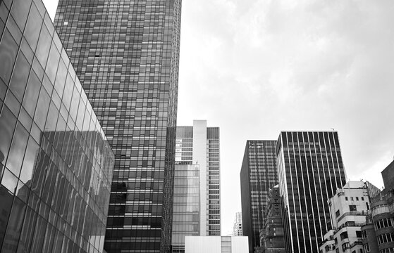 Black and white picture of New York City modern architecture on a cloudy day, USA.