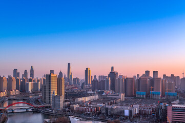 Fototapeta na wymiar Sunset waterfront downtown skyline with Tianjin high-rise building cityscape at Haihe riverside, , Tianjin city, China
