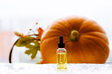 CBD oil bottle in front of a pumpkin