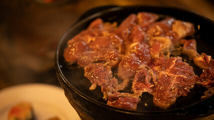 Roast beef on the stove in a pan pork shop