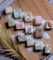 Oriental sweets on a wooden plate.
