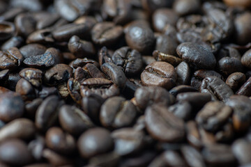 Roasted brown coffee beans as background. Perspective