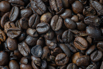 Roasted brown coffee beans as background. Top view
