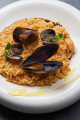 Risotto with mussels and rice in a white plate. Spanish cuisine, Seafood Paella