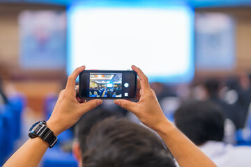Man taking photo to speaker on the stage present in conference hall or seminar meeting, event and seminar concept
