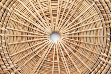 Close-up view of basketry plate isolated on a white background.
