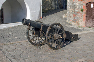 Old metal cannon on the wall of the fortress.