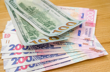 Banknotes of 100 American dollars and 200 Ukrainian hryvnias.  The ratio of the hryvnia to the dollar. Exchange Rates.