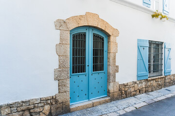 Turquoise blue door in a narrow street in the old town of Sitges, Barcelona