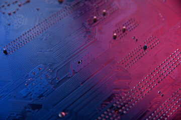 Close up of computer circuit board in blue and red lihgts