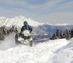 a Pro snowmobiler makes a jump with a big blast of snow and epic falls. Boondocker sports snowmobile