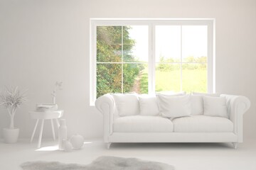 Fototapeta premium White living room with sofa and summer landscape in window. Scandinavian interior design. 3D illustration