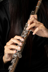 Golden flute played by a young woman © Andrea Tosi