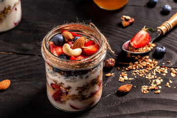 Breakfast from fresh natural yogurt with homemade granola and blueberries strawberry in glass jar. banner menu recipe place for text, top view