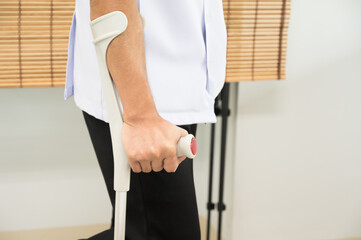 Patient try to walk with crutch in the physical therapy unit at hospital.Patient man ligament...