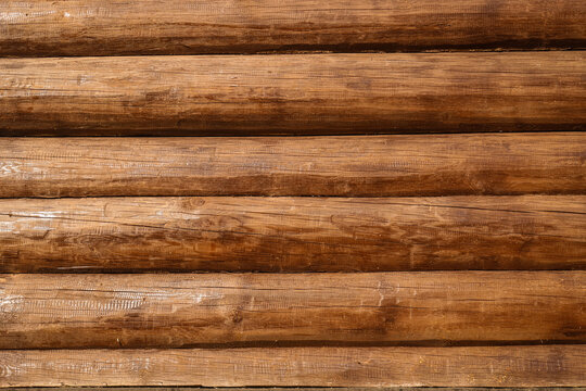 A wall of brown lacquer Logs. Textured background.