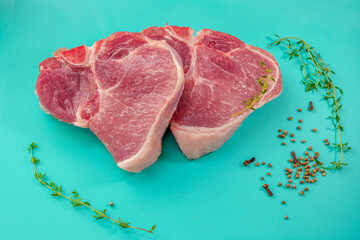 Raw fresh rib eye steaks and spice on the table. Meat ready for cooking.