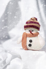 Little toy snowman on a white background. Winter, christmas and new year concept.