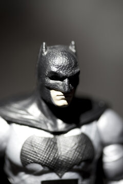 NEW YORK USA - NOV 11 2017: Batman action figure silhouetted against backlit surface and dramatic lighting. Batman is a DC Comics character also known as the Dark Knight and Caped Crusader 