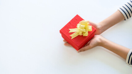 Woman hands holding beautiful gift box on white table. Happy Christmas and Happy New Year.