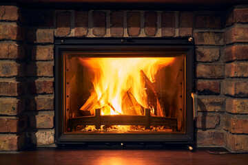 fireplace and fire close view as object or background, brick wall