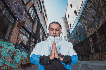 Mexican Latin young man, urban portrait meditating pose