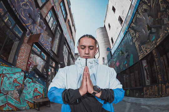 Mexican Latin young manl, urban portrait meditating pose
