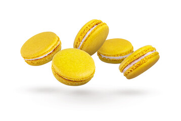 Lemon yellow macaroons fly on a white background. Beautiful yellow macaroons