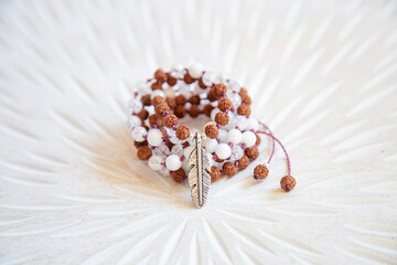 Indian seed and white jade beads mala necklace on white background