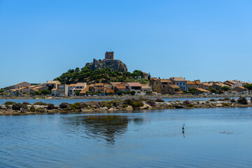 The ponds and the old Gruissan and the Barberousse tower in the background, in Aude in Occitanie, France