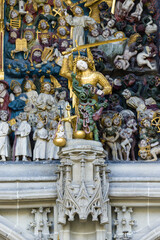 Fototapeta na wymiar Michael the Archangel with a raised sword in front of the Main entrance of the cathedral in Bern, Switzerland