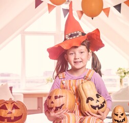 little girl in costumes with pumpkins for Halloween celebration