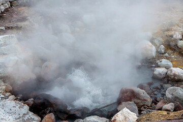 hot geyser gushing from the rocky ground