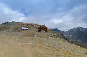 Lonely wooden house on top of a mountain.