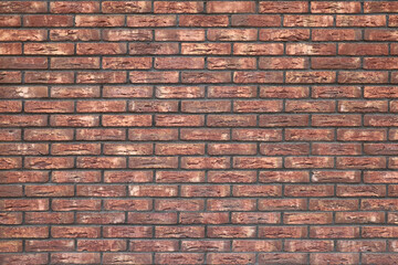 Red brick wall with textured surface and dark seams