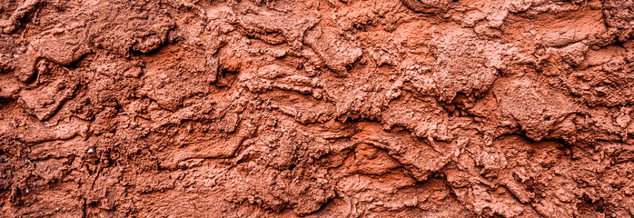Red dry grungy clay tennis background texture. Banner