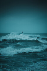 Wild North sea storm at a harbor with heavy storm waves on a dark rainy weather day in Denmark