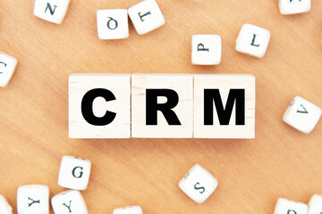 word concept written on a light table and light background. concept word CRM on cubes on a beautiful wooden background