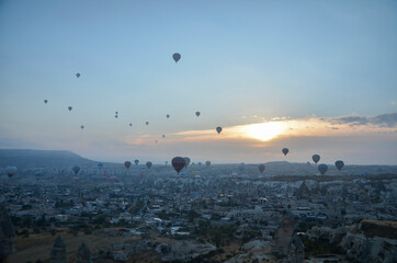 Colorful Hot air balloon flying over rocks and valley landscape at Cappadocia near Goreme Turkey