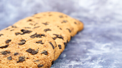 Soft, freshly baked chocolate chip cookies on a gray marble kitchen countertop. American traditional sweet pastry pastry, delicious homemade dessert. Culinary background. Copy space