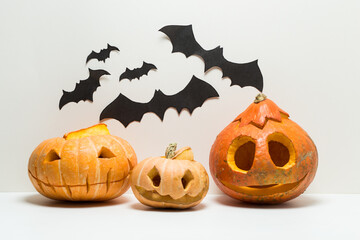 Three different  glowing Halloween Pumpkins with bats isolated on 
white background