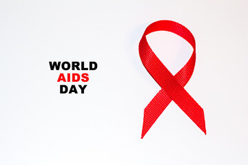 World Aids Day concept.Red ribbon as symbol of aids awareness on white background with copy space for text. 1 december World Aids Day concept.