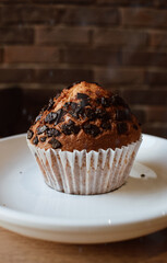 Chocolate cupcake on a plate in a cafe