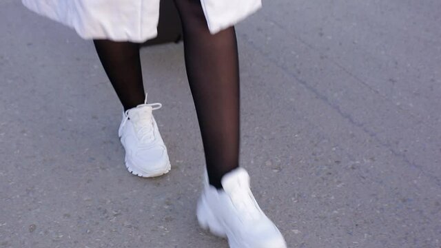 a lonely woman with a suitcase is walking on an empty road, the concept of travel, to be in an unknown place alone
